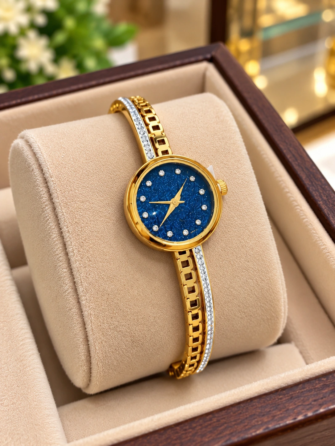 gold_blue_dial_watch_jewellery_display Elegant Crystal Studded Gold-Tone Bracelet Watch for Women - Image 1